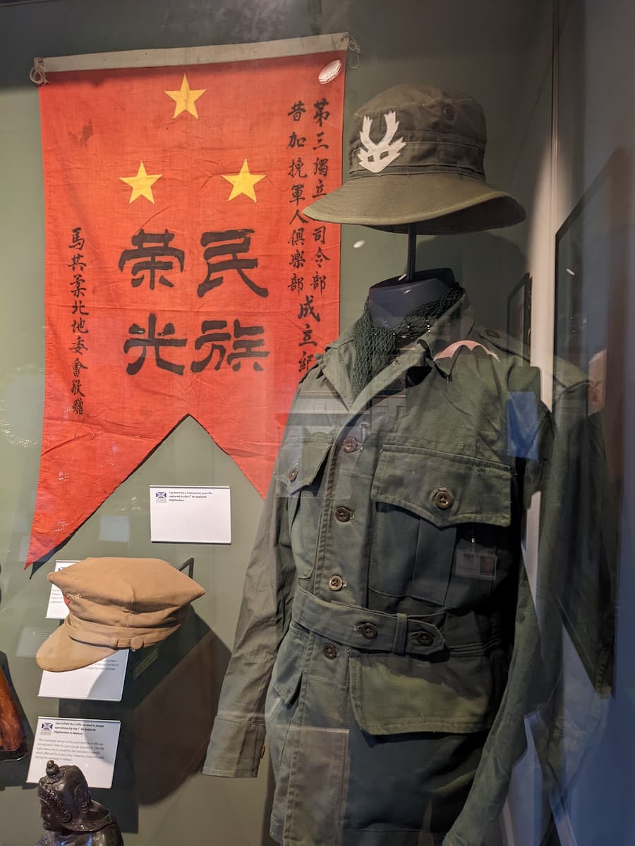 Seaforths jungle fatigues, MNLA cap and flag on display at The Highlanders' Museum